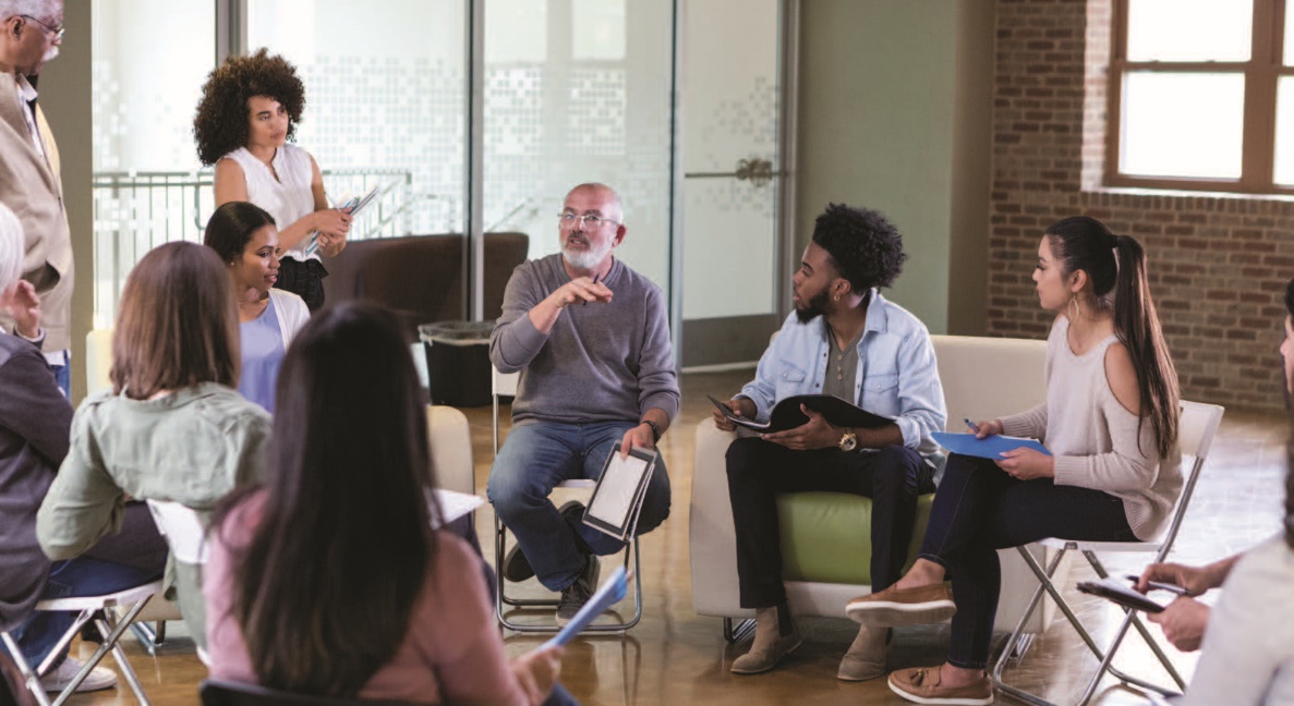 A group of people are gathered for a discussion.