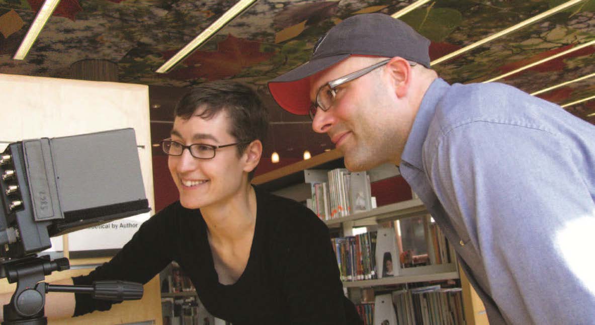 Two people look at a screen.